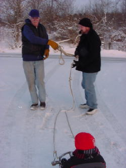 Grandpa and Daddy pull the sled to the top of the driveway